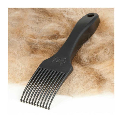 The CoatHook pet comb on a pile of deshedded dog fur